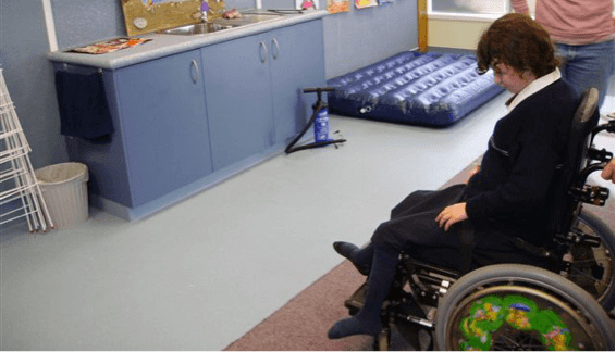 Sam is in a wheelchair being pushed towards the air bed.