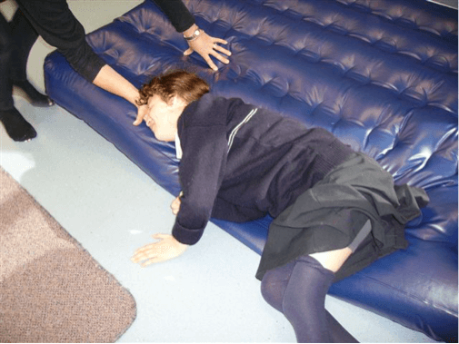 Sam lies on the edge of the airbed and the O &amp;amp; M specialist has her hand under her head.