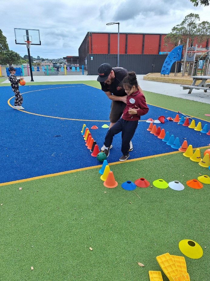 BLENNZ Wellington ākonga learning to kick a ball between cones.